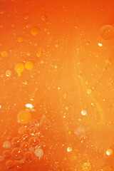 Gold Oil bubbles close up. circles of orange water macro. abstract shiny yellow background