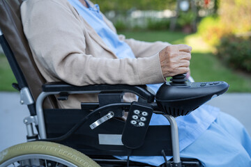 Asian senior or elderly old lady woman patient on electric wheelchair with remote control at nursing hospital ward, healthy strong medical concept