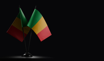 Small national flags of the Mali on a black background - obrazy, fototapety, plakaty