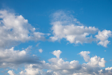 Naklejka na ściany i meble blue sky background with cumulus clouds, one is in a heart shape. copy space above