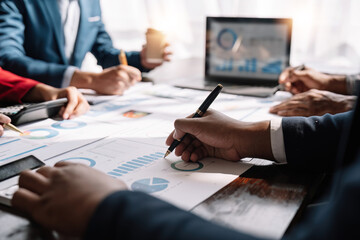 Financial analysts analyze business financial reports on a paperwork planning investment project...