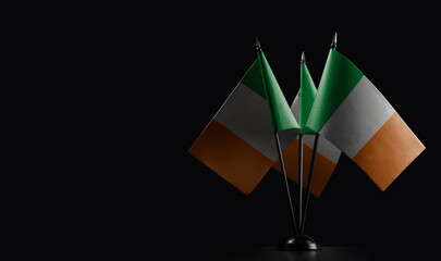 Small national flags of the Ireland on a black background