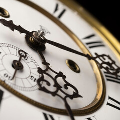 Vintage Clock with Hands.
Close up view on clock face of a historical watches with golden frame