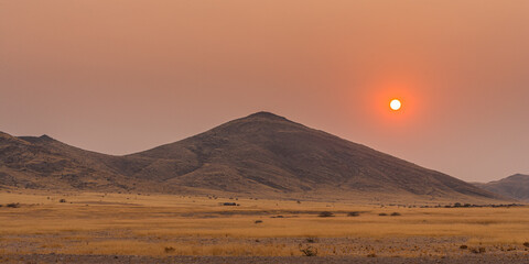 Sunrise over hills in semi-desert landscape in western Namibia