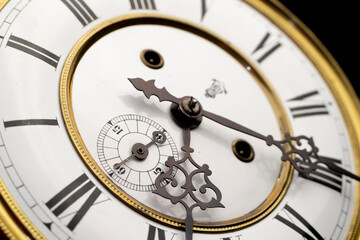 Vintage Clock with Hands.
Close up view on clock face of a historical watches with golden frame