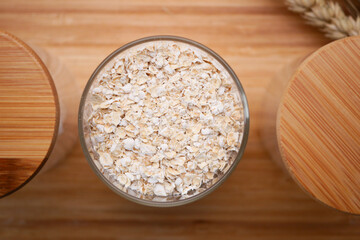 uncooked oats flakes black background, top down 