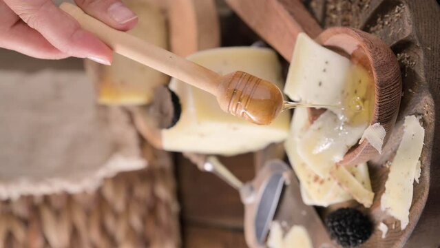 Pecorino cheese with truffle, traditional Italian sheep's milk cheese with truffle. A typical product of the dairy regions of Tuscany and Sardinia. Honey and cheese. High quality HD video. Vertical 