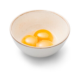 Bowl with egg yolks isolated. Three yolks in white bowl.