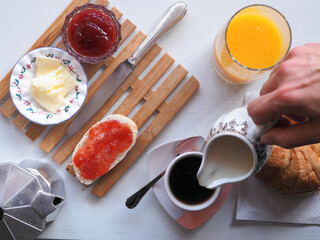 Continental breakfast with  buns with jam and coffee. Top view