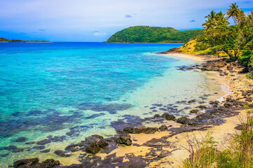Fototapeta na wymiar Tropical sandy beach at summer day in Fiji Islands, Pacific ocean