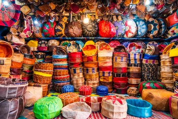 Poster Variety of leather poufs sold in huge shop next to tannery in Fes, Morocco,  Africa © malajscy