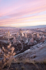 Fototapeta premium Stunning view of some rock formations in the Red & Rose Valley in Cappadocia during a beautiful sunrise. Goreme, central Anatolia, Turkey