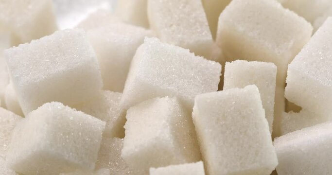  sugar cubes close-up. white sweet ingredient macro shot. turns around in front of the camera