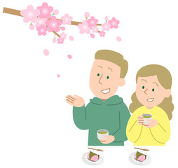 お花見をする外国人旅行者のカップル