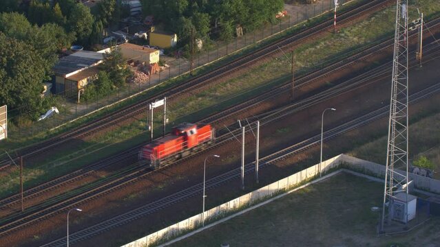 Aerial of Red Electric Locomotive Engine on Multiple Tracks Railway