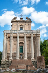 Fototapeta na wymiar Ruins of the Temple of Antoninus and Faustina - the front view of the San Lorenzo in Miranda church built inside the antique temple at the Sacred Road in Roman Forum in Rome, Italy