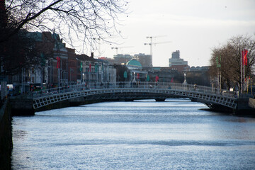 ha'penny bridge over liffey river in dublin in winter day