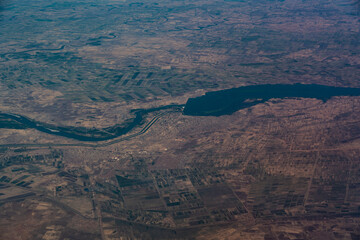 Aerial landscape view of area around the City of Sennar in Sudan, Africa with the Sennar Dam located in the river course of Blue Nile. The Town is  surrounded by large agricultural fields 