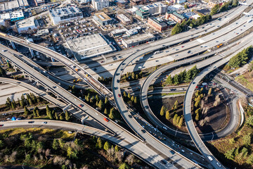 Aerial view of Highway 5 Interchange, located south of Seattle Downtown near the Stadion,  with lots of Car and Truck traffic driving in all directions   - Powered by Adobe