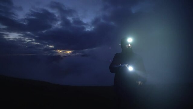 Search operation at dusk, at night, in the fog. The man got lost. A night walk with a lantern. Ray of the artificial world. Evening in the mountains. Dusk, lantern in hand. High quality 4k footage
