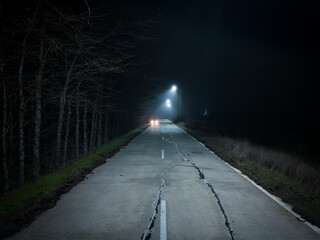 A trip on a rural forest road in a fog at night