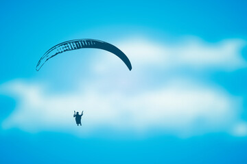 paragliding adventure paraglider in blue cloudy sky