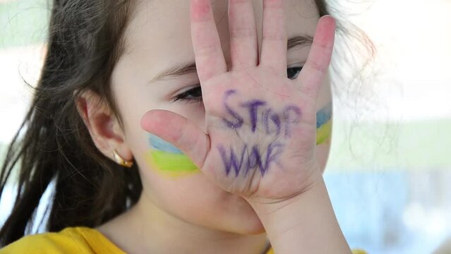 War in Ukraine. A child in tears because of the war. Children against war. Peace concept. Cold winter in Ukraine. Stop war. Russian aggression in Ukraine. Rocket strikes on Ukrainian cities.