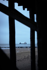 Cargo ship on shore in dramatic light in the North Sea, Netherland, Europe