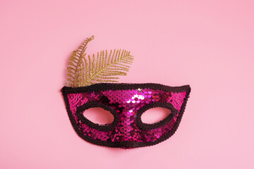 Festive face mask for carnival celebration on colored background