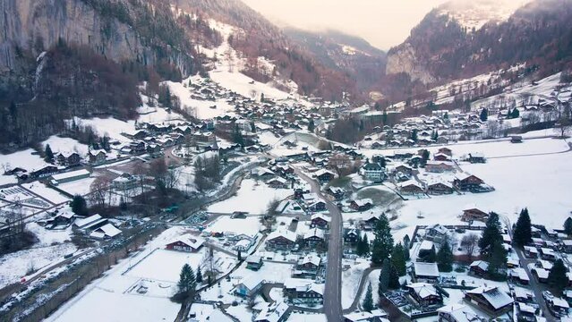 Aerial drone shot in Lauterbrunnen village at snowy winter in Switzerland. Popular tourist spots in Interlaken.