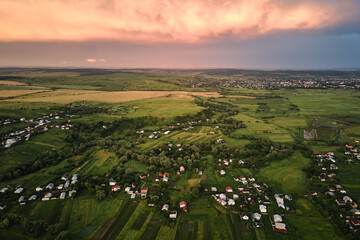 Aerial view of residential houses in suburban rural area at sunset