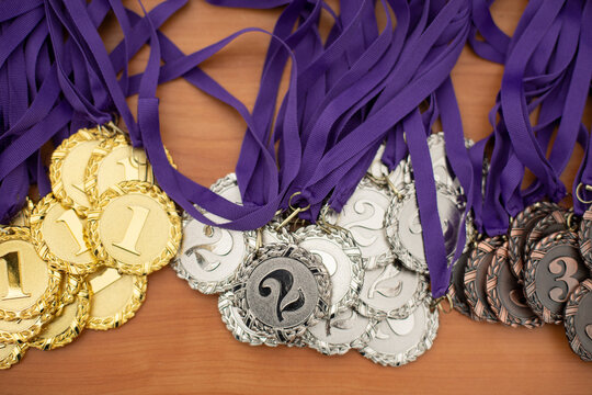 Medals made of metal. Sports awards. Mark of victory. Second place. - Powered by Adobe