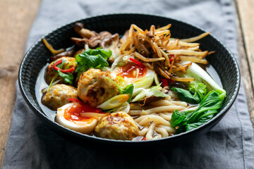 Ramen soup with meatballs and udon noodles