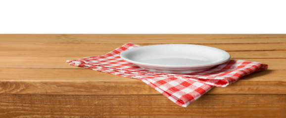 Empty wooden table with color tablecloth and plate