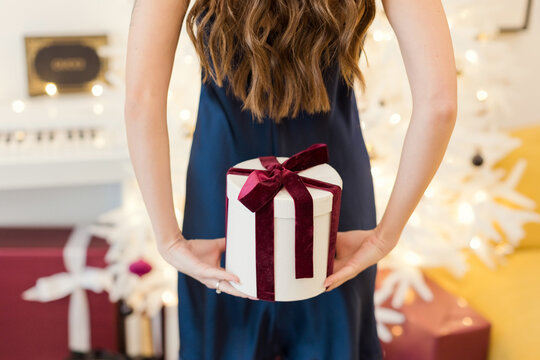 Woman holding Christmas gift box back