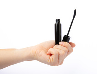 Mascara in hands isolated on white background