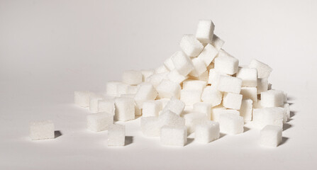 Refined sugar cubes pieces in pile, heap. Lot of sweet blocks. Overconsumption of sugary products...