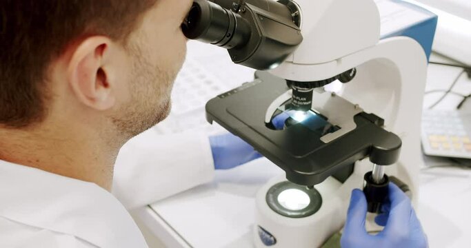 Using a microscope to examine the patients blood health condition. Microscope for blood examination at the clinic. Examining blood under the high-tech microscope equipment. Medical device.