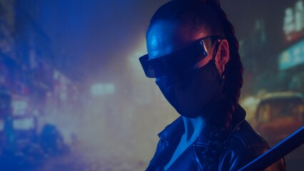 Cyberpunk ninja girl in a mask and with a katana. Beautiful female samurai woman on the background of Asian city downtown. © Acronym