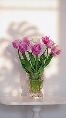 Fototapeta na wymiar Pink tulips flowers in the vase on white background
