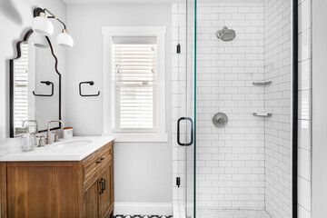 Styled Updated Bathroom Interior. Renovated white bathroom with contemporary design and modern...
