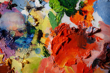 Colorful abstract texture. Smears of oil paint on an art palette. The concept of the modern school...