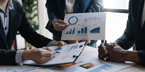 Business financial, accountant discussing with partner are meeting to audit finance planning sales to meet targets set in next year. stock market concept..