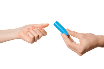 Rechargeable battery offer from a male hand to a female, isolate on a white background.