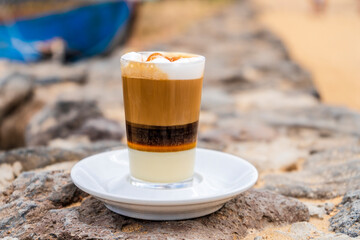 Delicious barraquito coffee with liquor and condensed milk, typical for Canary Island,  Spain