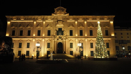 Fototapeta na wymiar Illuminated classical building with a Christmas tree in Valletta Malta