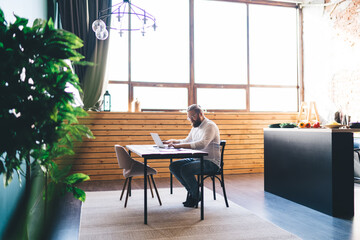 Freelancer typing on netbook at home