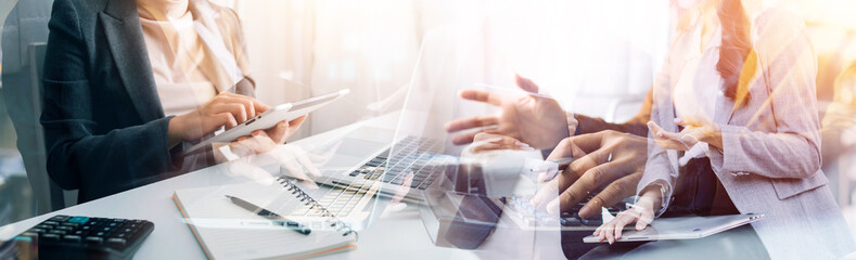 Businessman and team analyzing financial statement Finance task. with smart phone and laptop and tablet. Wealth management concept