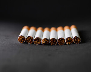 several cigarettes with a black background behind.
Stop smoking campaign concept