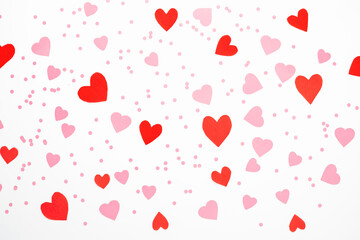 Flat lay Valentine's Day background made of red and pink hearts of white background. Valentines day creative concept. Top view, pattern.